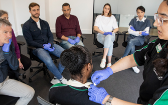 A class learning about first aid. A class learning about first aid.