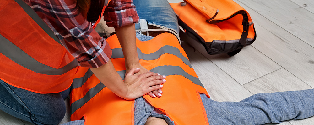A first responder providing first aid care for a casualty.