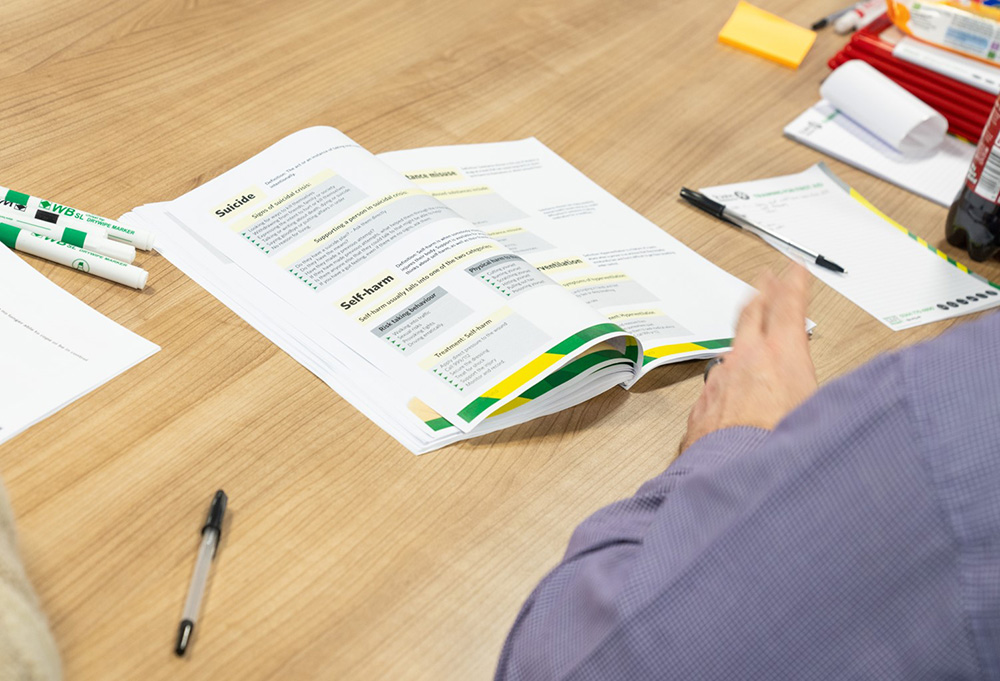 A mental health first aid student studying.