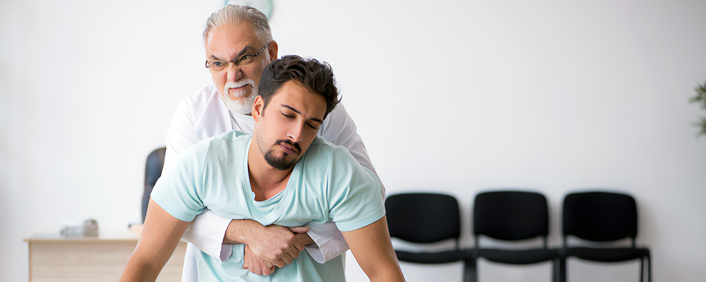 A man helping a person in an emergency situation.
