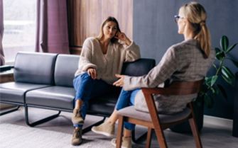 Two people having a heartfelt conversation. Two people having a heartfelt conversation.