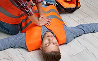 A first responder providing first aid care for a casualty. A first responder providing first aid care for a casualty.