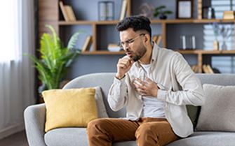 A man coughing. A man coughing.