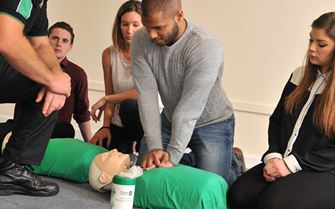 A group of first aid students learning about CPR. A group of first aid students learning about CPR.