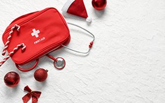 An arrangement of a first aid kit with Christmas decorations.