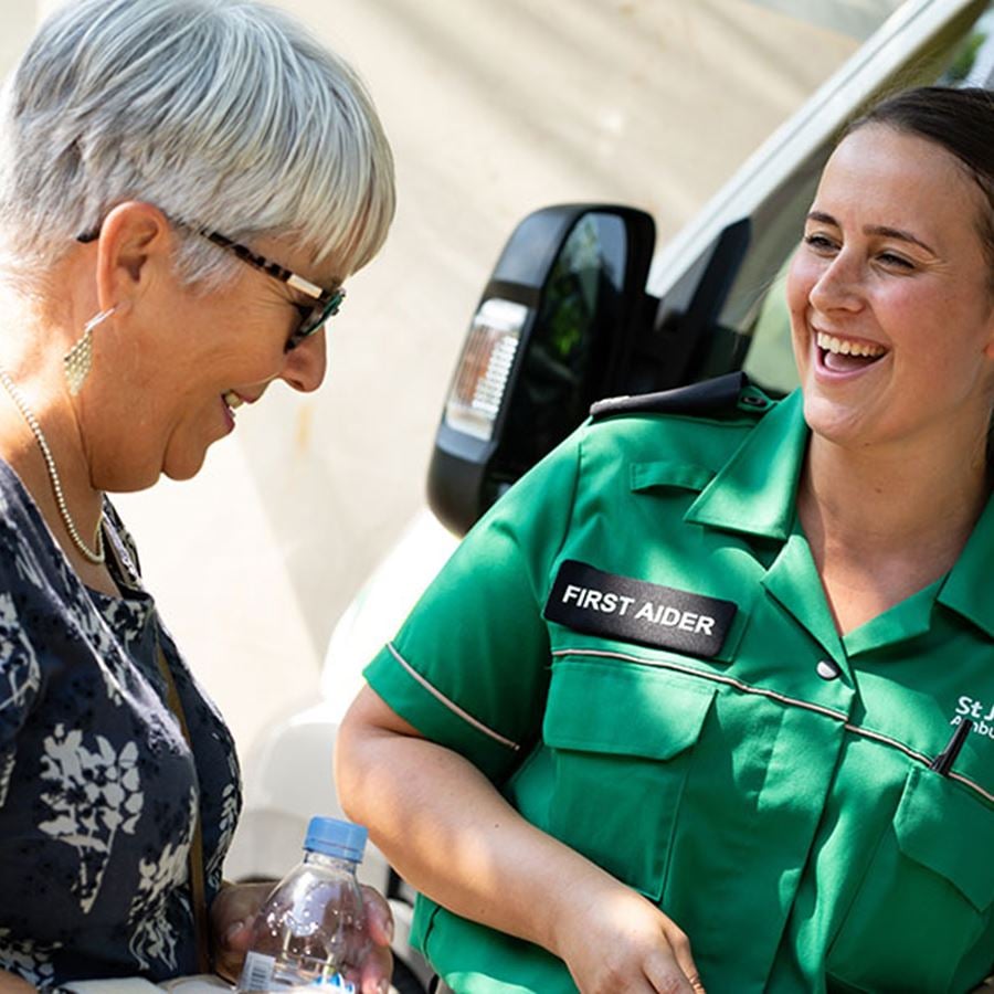First aider smiling with member of the public