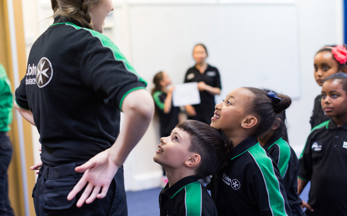 A Youth Leader standing in front of a group of Badgers.