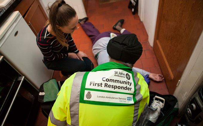 Community First Responder treating a collapsed woman Community First Responder treating a collapsed woman