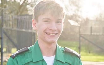 Teenage volunteer smiling at the camera