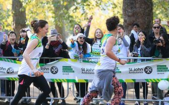 St John Ambulance supporter cheering on runners at Royal Parks Half Marathon.