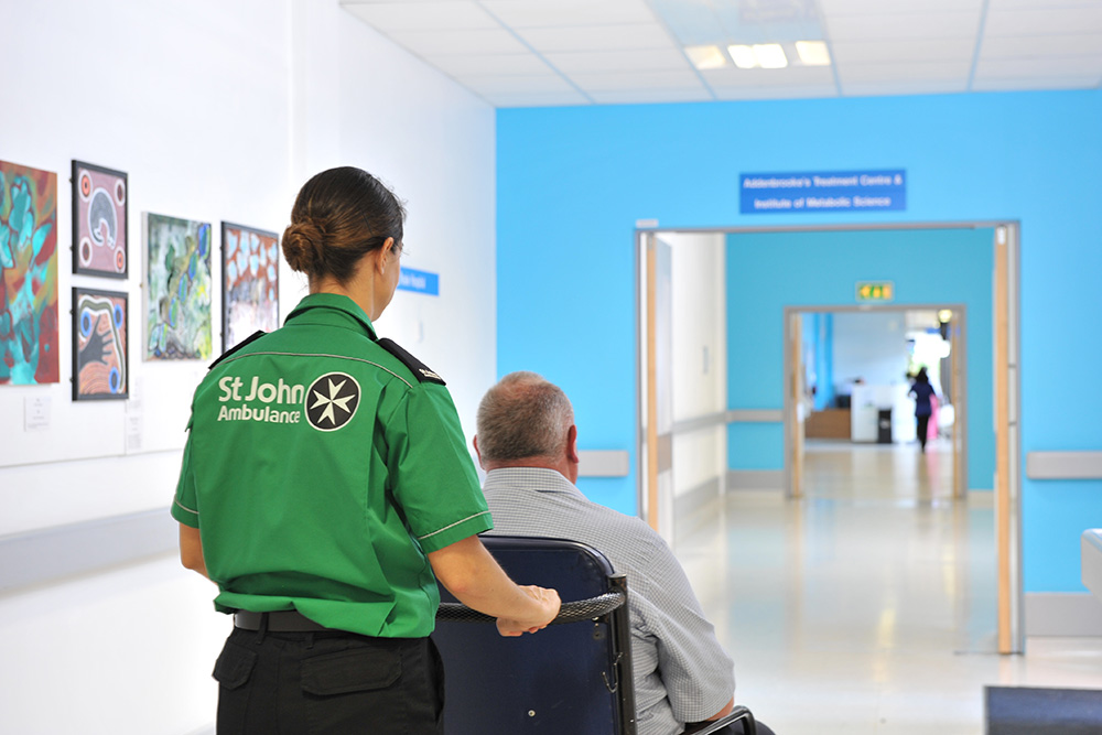 St John Ambulance crew member transporting patient