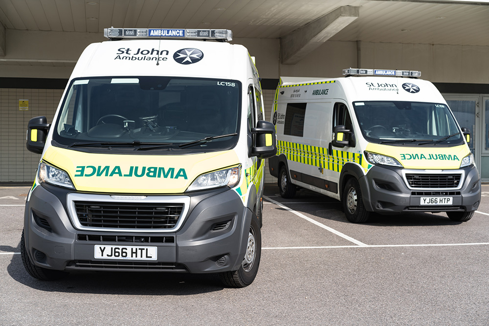 2 ambulances with St John Ambulance logos parked facing the camera. 