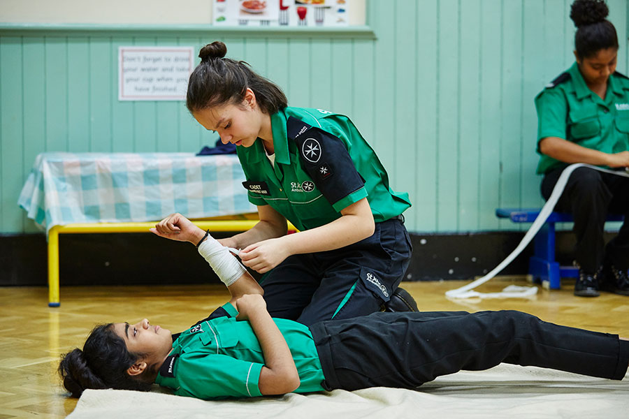 Cadet learning how to apply a bandage