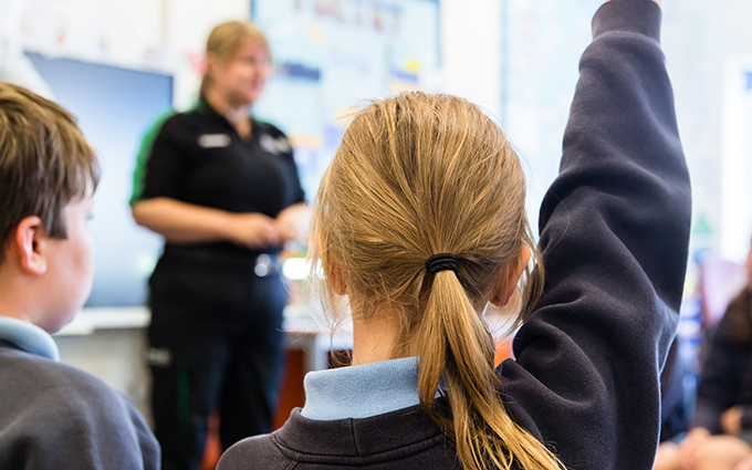 School children learning first aid in the classroom