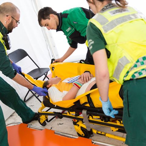Volunteers helping a casualty at a half marathon Volunteers helping a casualty at a half marathon