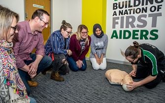 A St John Ambulance first aid trainer teaching CPR