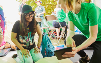 Image of a Cadet practising CPR and trainer with screen Image of a Cadet practising CPR and trainer with screen
